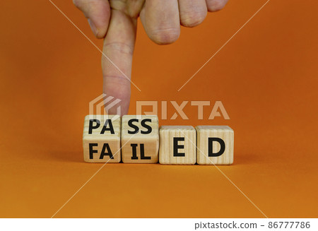 Passed or failed symbol. Businessman turns wooden cubes and changes the word 'failed' to 'passed' on a beautiful orange table, orange background. Business and passed or failed concept. Copy space. Passed or failed symbol. Businessman turns wooden cubes and changes the word 'failed' to 'passed' on a beautiful orange table, orange background. Business and passed or failed concept. Copy space. 86777786
