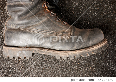Old Man Army Boot on Ruberoid Grain Surface Old Man Army Boot on Ruberoid Grain Surface 86778429