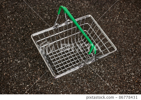 Metal Shopping Basket on Ruberoid Grain Surface 86778431