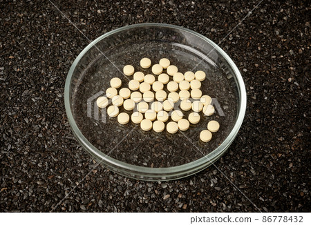 Medical Tablettes in Petri Dish on Ruberoid Grain Surface 86778432