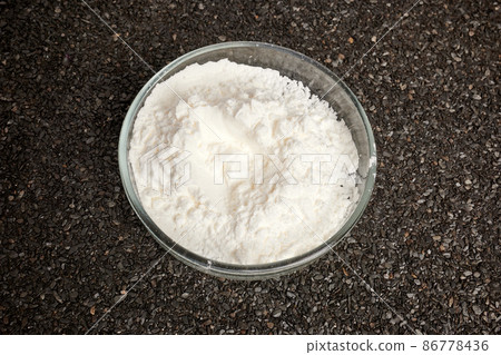 Cocaine Powder in Petri Dish on Ruberoid Grain Surface 86778436