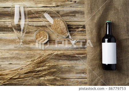 A bottle of beer and grain. Top view. Free space for text. A bottle of beer and grain. Top view. Free space for text. 86779753