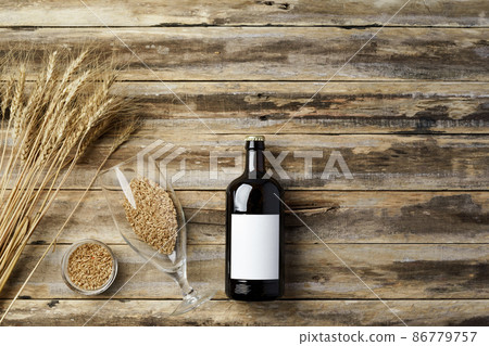 A bottle of beer and grain. Top view. Free space for text. A bottle of beer and grain. Top view. Free space for text. 86779757