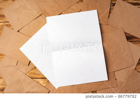 Stack of envelopes on working desk top view. Business mail 86779782