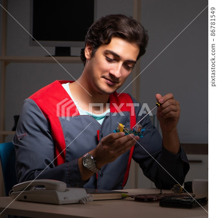 The young handsome repairman repairing computer The young handsome repairman repairing computer 86781549