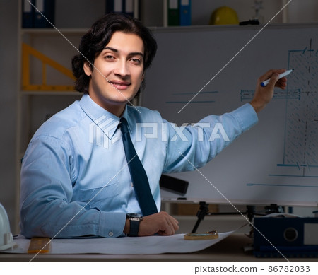 The young male architect working night at office The young male architect working night at office 86782033