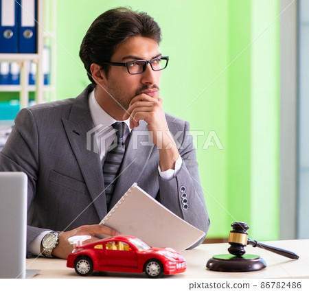 Young handsome lawyer working in the office 86782486