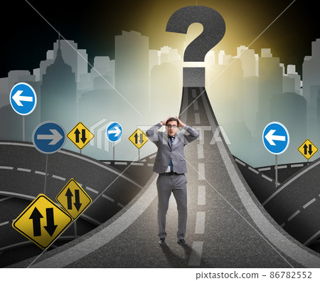 Businessman in uncertainty concept on road intersection crossroa 86782552