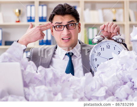 Businessman in paper recycling concept in office Businessman in paper recycling concept in office 86783299