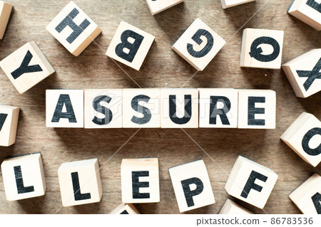 Alphabet letter block in word assure with another block on wood background 86783536