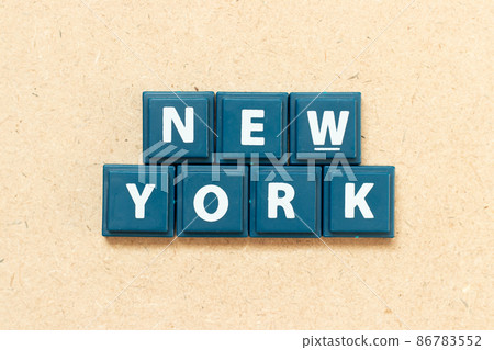 Tile alphabet letter in word new york on wood background 86783552
