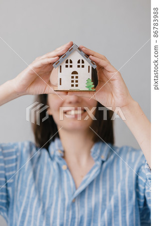 a beautiful small model of a house in women's hands 86783988