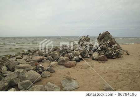 Cape Kolka on the Baltic Sea is the meeting point of the sea and Gulf of Riga. Latvia. The ruins of a ruined ancient lighthouse are in the foreground. High quality photo Cape Kolka on the Baltic Sea is the meeting point of the sea and Gulf of Riga. Latvia. The ruins of a ruined ancient lighthouse are in the foreground. High quality photo 86784196