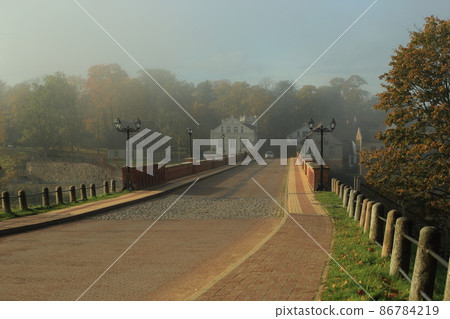 Morning autumn foggy road to Kuldiga, Latvia. High quality photo Morning autumn foggy road to Kuldiga, Latvia. High quality photo 86784219