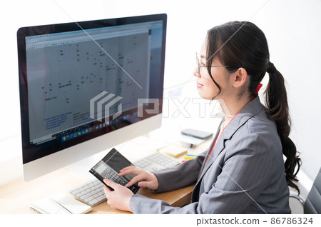 Female engineer working in front of a computer Female engineer working in front of a computer 86786324