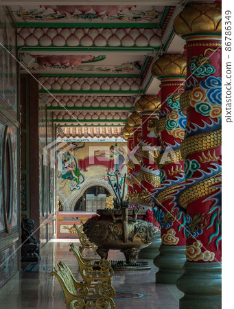 The magnificent of Chinese-style temple corridor with sculptured dragons pillars, Large incense burner decorated with dragon pattern. The magnificent of Chinese-style temple corridor with sculptured dragons pillars, Large incense burner decorated with dragon pattern. 86786349