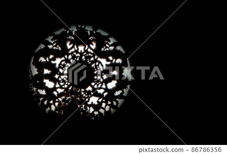 Twin Chinese dragons sculpture decorate on chinese-style circular window through which a ray of light passes. Twin Chinese dragons sculpture decorate on chinese-style circular window through which a ray of light passes. 86786356