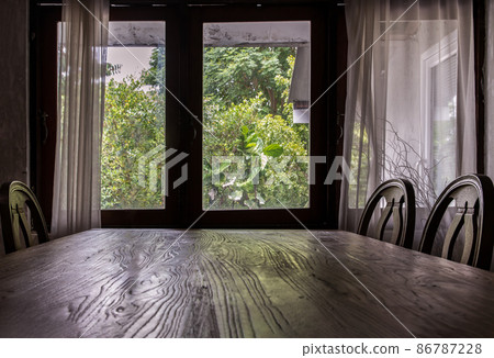 Wooden eating table and chairs in dining room. Wooden eating table and chairs in dining room. 86787228