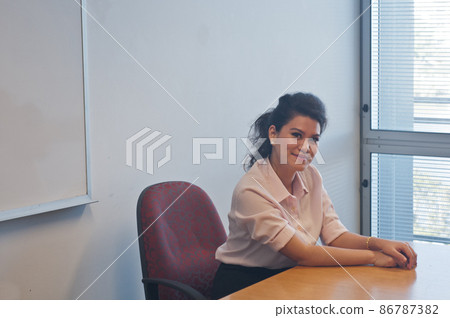 Business woman sits in the office with smile 86787382