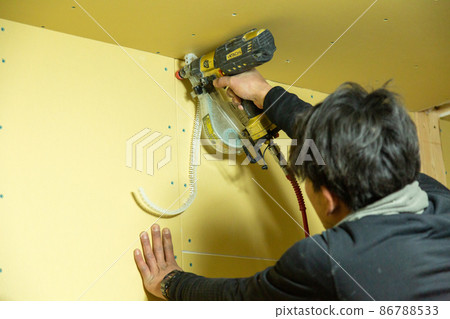 Carpenter doing new detached house construction work 86788533