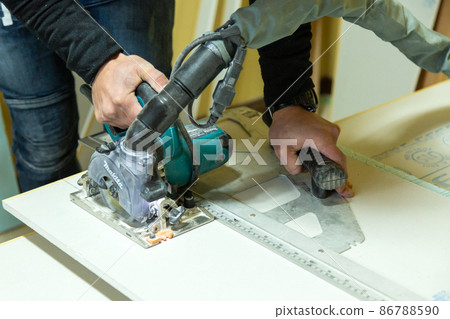 Carpenter doing new detached house construction work 86788590