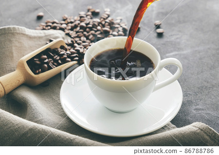 Hot coffee poured into a cup 86788786