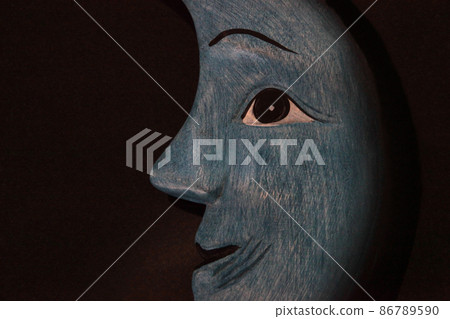 A blue crescent moon with a mysterious and mysterious smile A blue crescent moon with a mysterious and mysterious smile 86789590