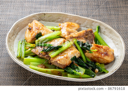 Stir-fried yellowtail and Japanese mustard spinach in oyster sauce. Stir-fried yellowtail and Japanese mustard spinach in oyster sauce. 86791618