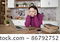 Bored sleepy asian woman sitting at desk with laptop, holding head, resting on hand, sleeping at workplace, tired young female feeling drowsy, lazy and unmotivated student, boring job, lack of sleep 86792752