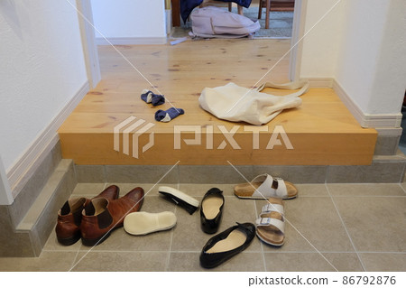 The shoes on the front door that were taken off 86792876