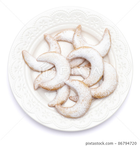 Traditional German or Austrian Vanillekipferl vanilla kipferl cookies on a plate isolated on white background 86794720