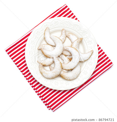 Traditional German or Austrian Vanillekipferl vanilla kipferl cookies on a plate isolated on white background 86794721
