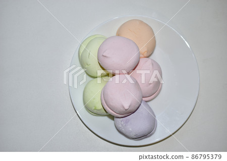 Colorful delicious marshmallows on a white plate Colorful delicious marshmallows on a white plate 86795379
