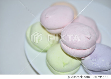 Colorful delicious marshmallows on a white plate Colorful delicious marshmallows on a white plate 86795382