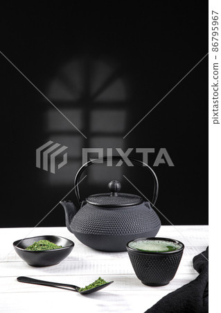 Matcha tea powder and tea accessories on white wooden base .Traditional japanese drink. Vertical format. Matcha tea powder and tea accessories on white wooden base .Traditional japanese drink. Vertical format. 86795967