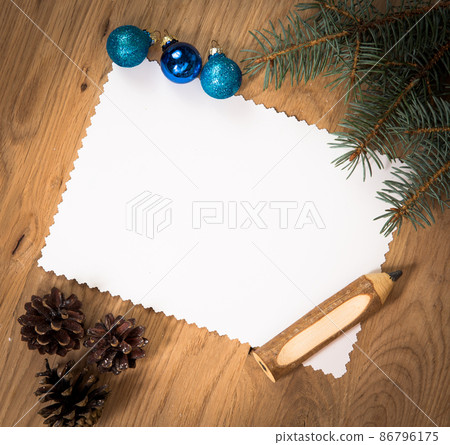blank sheet of paper on the wooden floor with a pencil and Christmas decorations blank sheet of paper on the wooden floor with a pencil and Christmas decorations 86796175