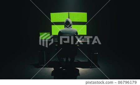 Anonymous hacker using computer in darkness 86796179