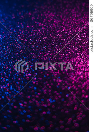 Bokeh color gradient. Neon light overlay. Blur ultraviolet sequin glare. Defocused blue magenta pink glow glitter texture on dark black abstract background. Bokeh color gradient. Neon light overlay. Blur ultraviolet sequin glare. Defocused blue magenta pink glow glitter texture on dark black abstract background. 86796909