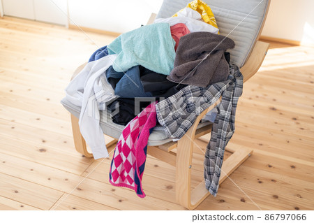 A pile of laundry on the chair A pile of laundry on the chair 86797066