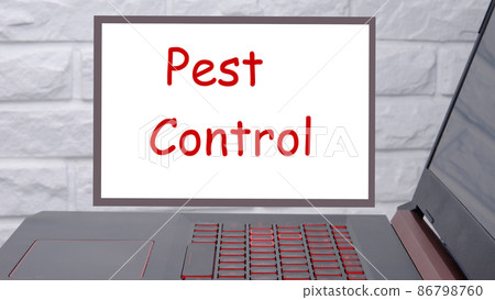 Pest Control a phrase written on a magnetic board next to a laptop with a glowing keyboard 86798760