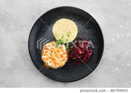 Kiev citlet with mashed potato and pickled beetroot on a plate, top view Kiev citlet with mashed potato and pickled beetroot on a plate, top view 86799905