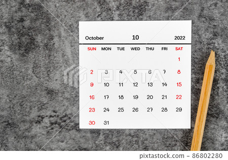 October 2022 and wooden pencil on vintage dark background. 86802280