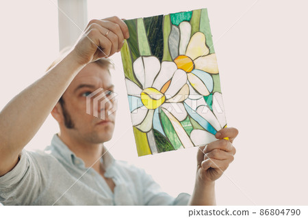 Restorer master male checking stained glass window project Restorer master male checking stained glass window project 86804790