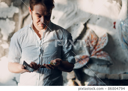 Craftsman male master portrait hold hammer and smalt glass pieces in arm hand for mosaic artwork in workshop. 86804794