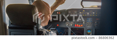 Focused professional pilot sitting in an airplane cabin, ready for takeoff 86806362