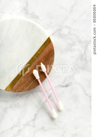 Flat lay top view pink reusable silicone swab buds on white marble background 86806864