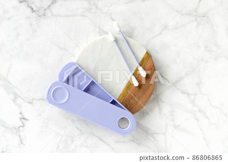 Flat lay top view violet reusable silicone swab buds on white marble background 86806865