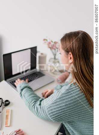 Mockup image of a woman using and typing on laptop with blank white screen. Female hobby. Working on research project online concept. Handmade macrame shop, diy Mockup image of a woman using and typing on laptop with blank white screen. Female hobby. Working on research project online concept. Handmade macrame shop, diy 86807007