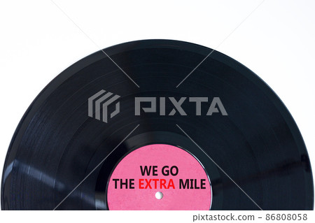 We go the extra mile symbol. Concept words We go the extra mile on retro black vinyl disc. Beautiful white background, copy space. Business and we go the extra mile concept. We go the extra mile symbol. Concept words We go the extra mile on retro black vinyl disc. Beautiful white background, copy space. Business and we go the extra mile concept. 86808058