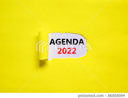 2022 agenda new year symbol. Words '2022 agenda' appearing behind torn yellow paper. Beautiful yellow background. Business, 2022 agenda new year concept, copy space. 86808094
